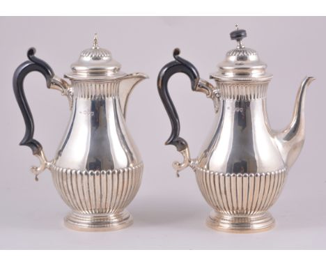 A Victorian pear-shaped coffee pot, and matching hot water jug, by William Hutton & Sons Limited, London 1894, each semi-flut