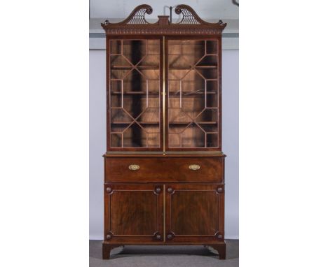 A George III mahogany  bookcase secretaire, fretted swan-neck pediment, over a dentil frieze with pendants, two astragal glaz