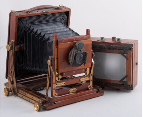 A Vintage brass and mahogany half-plate camera, British made, no. 183.