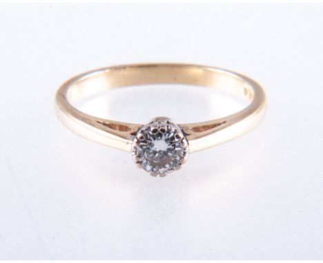 A diamond solitaire ring, the brilliant cut stone double claw set in a traditional 18 carat yellow and white gold mount with 