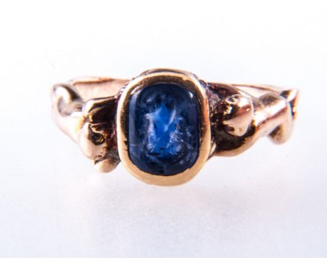 A yellow metal intaglio carved ring, the blue stone, 7mm x 5mm, carved with the bust of a Roman with garland to head, collet 