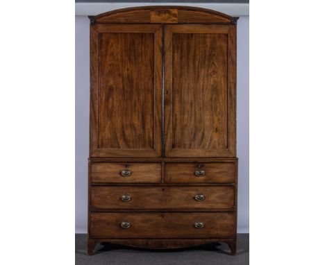 A George IV mahogany linen press, adapted as a wardrobe, reeded and curved pediment piece, two panelled doors to the upper se