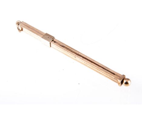 A 9 carat yellow gold swizzle stick, the retractable swivel with slide action in a 9 carat yellow gold square section engine 