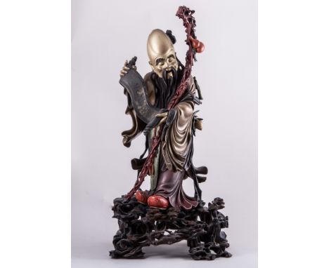 A Chinese lacquered figure, figure with a staff and a scroll, open work base, a gilt stencil Shen Shao An Shoon Kee Foochow, 