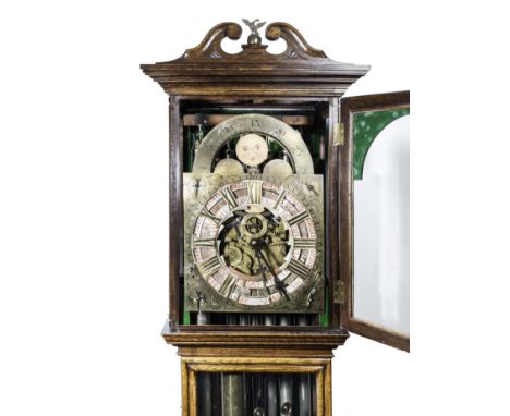 An oak longcase clock, arched brass dial, signed Hugh Inglis, Witley, 1912, with three revolving chapters indicating day, dat