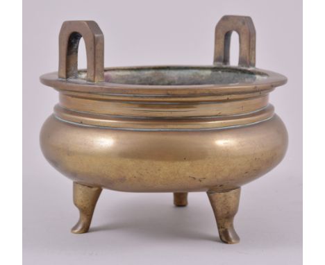 A Chinese bronze koro, Ming style, twin-lug handles, slightly compressed rounded bowl, cast six character seal mark, tripod l