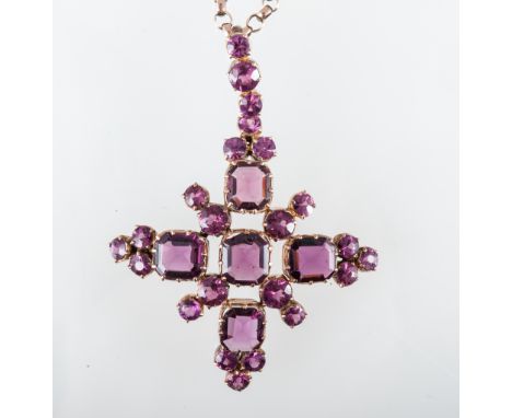 A pink faceted stone pendant and chain, a yellow metal cross shaped pendant, 45mm, claw set with five major rectangular step 