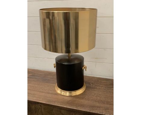 A contemporary table lamp with drum base, handles to sides and metal shade. 