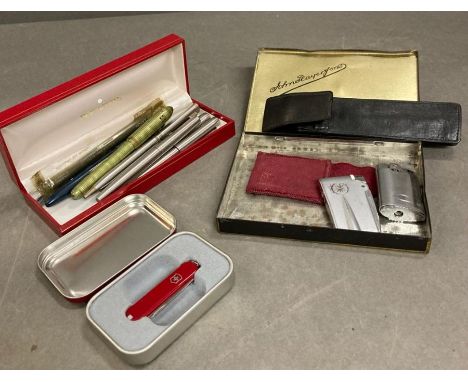 A selection of fountain pens, Ronson lighters and a Swiss army pen knife 