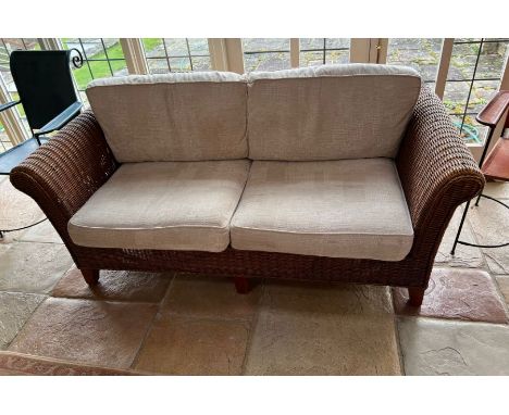 A two seater rattan sofa (H80cm W180cm D88cm)Condition Report no holes to rattan or repairs light stains to cushions&nbsp;