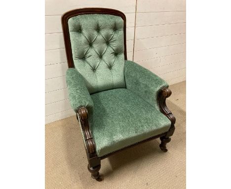 An oak framed button back salon chair with scrolled arms on turned legs (H100cm W70cm D70cm)