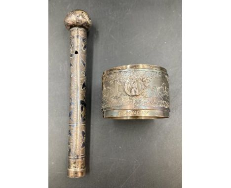 A white metal napkin ring engraved with Roc Amadour and a white metal parasol handle