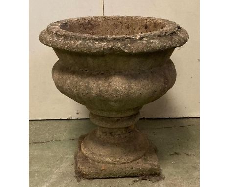 A round planter on a square base 