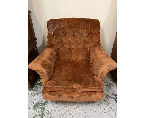 An Easy mid century armchair with winged arms and button back 