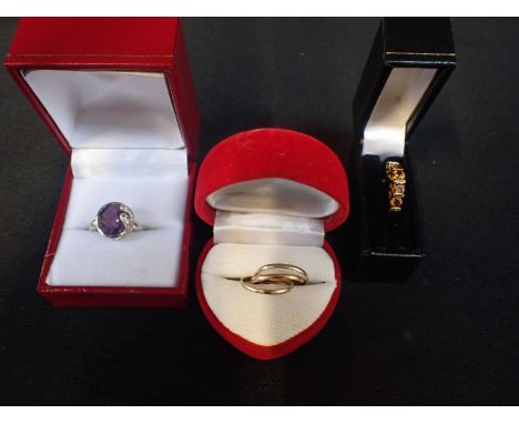 A 9ct WHITE GOLD DRESS RINGwith faceted stone, another dress ring, and a three-colour yellow metal conjoined ring (3)