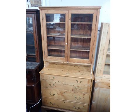 A 19th CENTURY SECRETAIRE CHESTwith associated glazed top section with fixed shelves, the lower section with dummy drawers hi