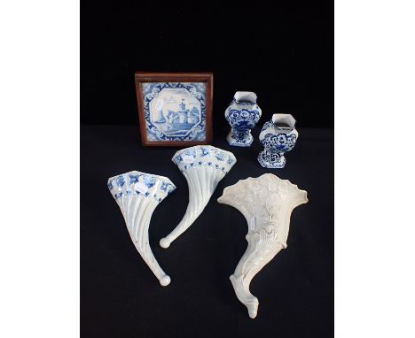 A PAIR OF DELFTWARE WALL POCKETSwith a framed Delft tile and a cornucopia wall pocket and two small Delft vases