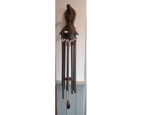 AN EDWARIAN ART NOUVEAU 'WIND CHIME' DINNER GONGor porch doorbell, with scrolling wall bracket on oak backing, and silk tasse