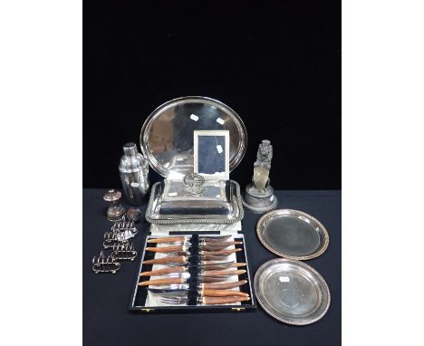 A SILVER-PLATED HERALDIC LION RAMPANTformerly a table lighter 22cm high, a set of four plated miniature toast racks, other pl