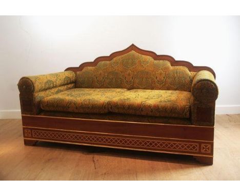 A HARDWOOD TWO-SEATER SOFA WITH ARCHED MORESQUE BACK RAILSmodern, upholstered throughout in arabesque patterned fabric, highl