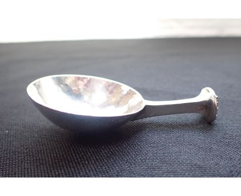AN A. E. JONES SILVER CADDY SPOONwith rose finial, 1919