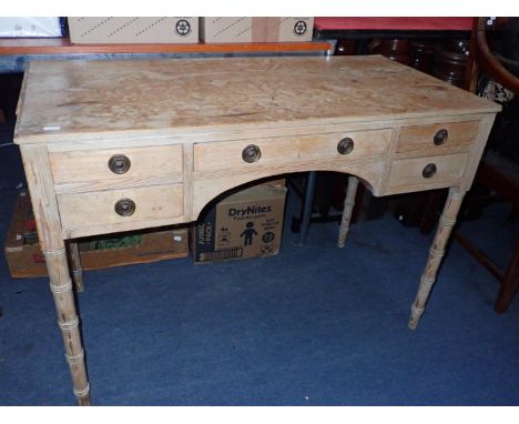 A REGENCY STRIPPED PINE DRESSING TABLEon ring-turned legs 103cm wide (some loss to edge moulding)