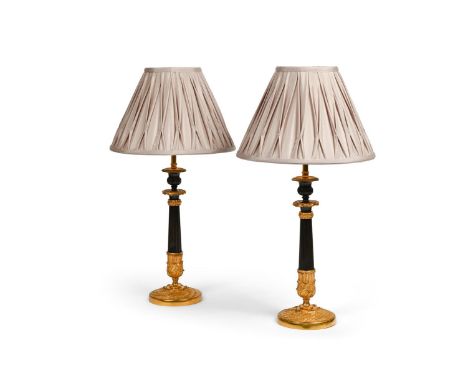 A PAIR OF FRENCH GILT AND PATINATED BRONZE LAMP BASES  FIRST HALF OF THE 19TH CENTURY AND LATER  Now wired, with pleated shad