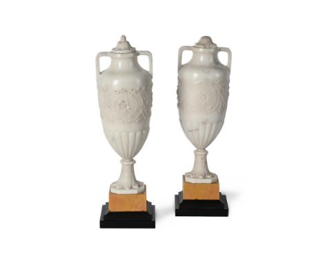 A PAIR OF NEOCLASSICAL WHITE MARBLE VASES  LATE 19TH OR EARLY 20TH CENTURY   On giallo marble bases  31.5cm high, the bases 9