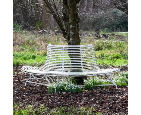 A HAND FORGED AND WHITE PAINTED SEMI CIRCULAR 'ARRAS' TREE SEAT OF RECENT MANUFACTURE 86cm high, 193cm wide, 93cm deep 