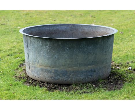 A LARGE PATINATED COPPER AND RIVETED PLANTER CONTEMPORARY With a rollover edge, tapering cylindrical body, pierced for draina