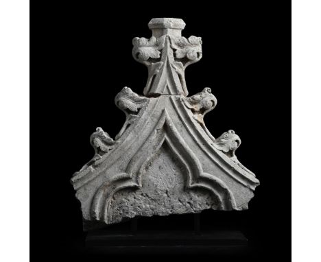 A FRAGMENT OF A GOTHIC LIMESTONE GABLE PROBABLY 15TH OR 16TH CENTURY  Now mounted on black metal stand  the fragment 63cm hig