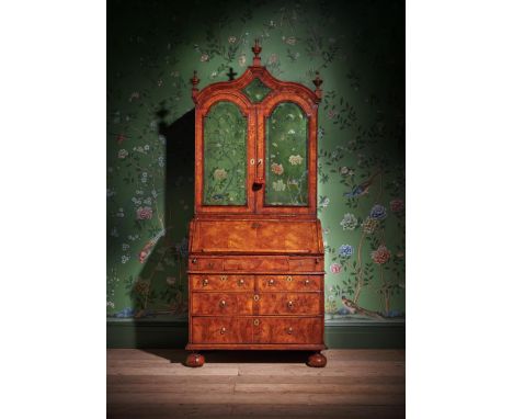 A QUEEN ANNE WALNUT AND FEATHERBANDED BUREAU CABINET CIRCA 1710 The fall front opening to a fitted interior and a sunken well