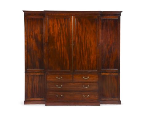 A REGENCY MAHOGANY BREAKFRONT CLOTHES PRESS ATTRIBUTED TO GILLOWS, CIRCA 1820 The panelled doors enclosing cedar lined trays 