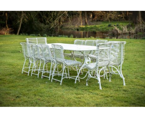 A HAND FORGED AND WHITE PAINTED GARDEN 'ARRAS' SUITE OF RECENT MANUFACTURE Comprising a large rectangular dining table and a 