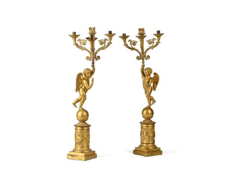 A PAIR OF FRENCH EMPIRE ORMOLU CHERUB CANDELABRA  EARLY 19TH CENTURY  Ormolu and gilt metal, winged cherub figure each suppor