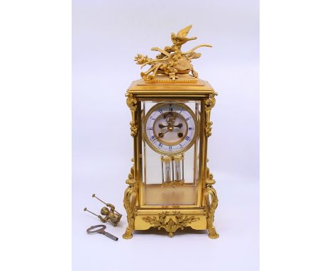 A large French gilt ormolu mantle clock, the enamel dial marked Paris, pendulum with swinging cherub en suiteProvenance from 