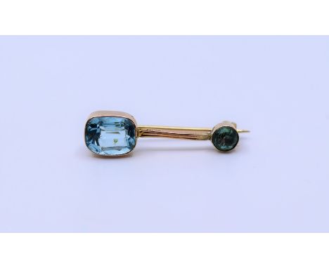 A Peridot bar brooch&nbsp; and blue topaz stick pin&nbsp;