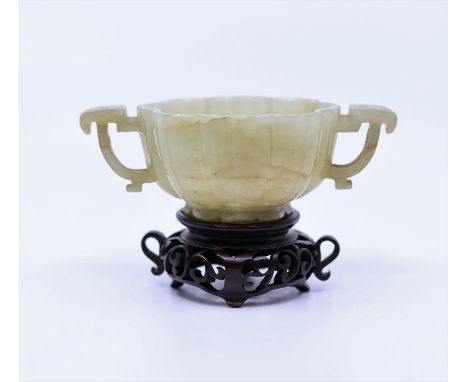 A Chinese Qing dynasty jade libation cup with later wooden stand&nbsp;