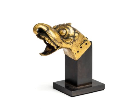 A COPPER GILT FINIAL IN THE FORM OF MAKARA HEAD, PROBABLY DECCAN, INDIA, CIRCA 1700 with bulbous eyes, the gaping mouth with 