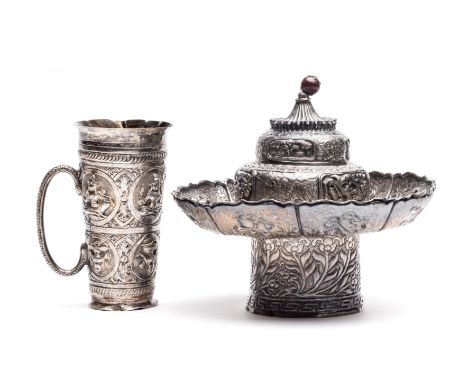 TWO SILVER OBJECTS, INDIA AND TIBET, CIRCA 1900 comprising an Anglo-Indian spirit measure, and a Tibetan butter lamp, the lat