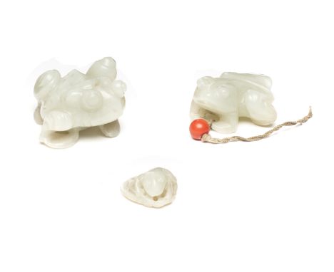 TWO CHINESE CARVED JADE FROGS, 19TH / 20TH CENTURY each in crouching pose, the stone of pale celadon tone, 4cm and 5cm long; 