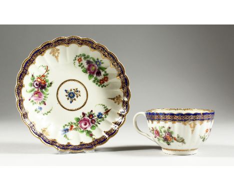 A WORCESTER TEACUP AND SAUCER painted with the Royal Marriage pattern, so-called after a service made for George III.
