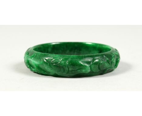 A CARVED JADE BANGEL.