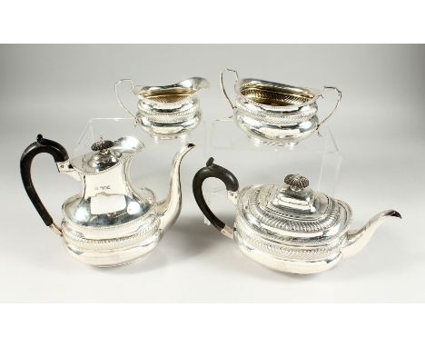 A VICTORIAN SILVER FOUR PIECE TEA SET with gadrooned edge, comprising tea pot, hot water jug , sugar basin and milk jug. Lond