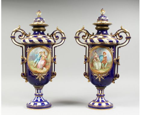 A SUPERB LARGE PAIR OF SEVRES TWO HANDLED VASES AND COVERS, rich blue and white ground edged in gilt with reverse oval panel 