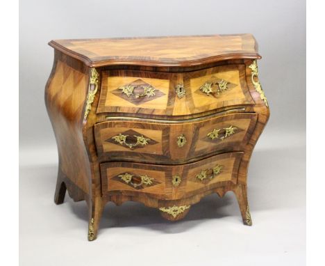 A GOOD SERPENTINE FRONTED BOMBE COMMODE, with cross banded top three long drawers with ormolu mounts and handles on curving l