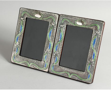 A PAIR OF ART NOUVEAU STYLE SILVER AND ENAMEL PHOTOGRAPH FRAMES 7.5ins x 5.5ins