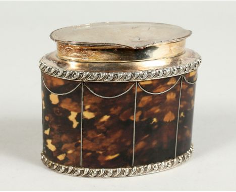 A FAUX-TORTOISESHELL OVAL TEA CADDY with plated mounts. 4" wide