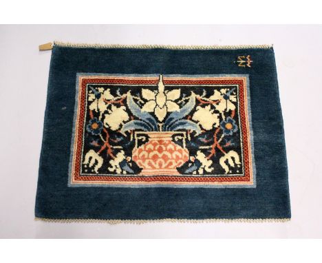 MORRIS &amp; CO., HAMMERSMITH STUDIO, a small wool rug, blue ground, the central rectangular panel woven with a design of flo