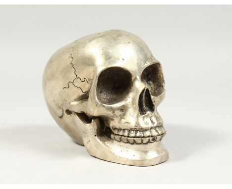 A SILVER PLATED BRONZE SKULL 5ins high